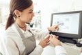 Cheerful cashier using digital device for payment Royalty Free Stock Photo