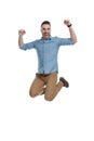 Cheerful casual man celebrating and shouting while jumping Royalty Free Stock Photo