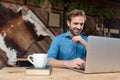 Cheerful casual man laughing and reading from his laptop Royalty Free Stock Photo