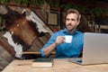 Cheerful casual man looking away and drinking his coffee Royalty Free Stock Photo