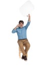 Cheerful casual man talking on phone and holding speech bubble Royalty Free Stock Photo