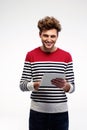 Cheerful casual man using tablet computer Royalty Free Stock Photo