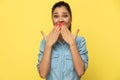 Cheerful casual woman covering her mouth with both hands Royalty Free Stock Photo