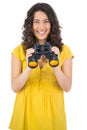 Cheerful casual young woman using binoculars Royalty Free Stock Photo