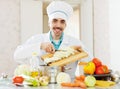 Cheerful caucasian cook does veggy lunch Royalty Free Stock Photo