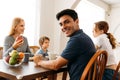 Happy family talking while enjoying breakfast