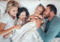 Cheerful caucasian family relaxing in bed together,playing. Happy parents tickling their children while lying in bed Royalty Free Stock Photo