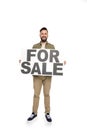 cheerful caucasian man holding for sale banner in hands