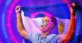 Cheerful caucasian soccer player with argentina flag screaming over illuminated circles Royalty Free Stock Photo