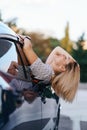 Cheerful woman coming out window of her car Royalty Free Stock Photo