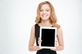 Cheerful charming young business woman holding blank screen tablet Royalty Free Stock Photo