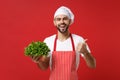 Cheerful chef cook or baker man in striped apron white t-shirt toque chefs hat isolated on red background. Cooking food Royalty Free Stock Photo