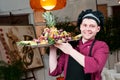 Cheerful chef cook with fruits