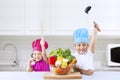 Cheerful chef kids in kitchen