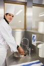Cheerful chef washing hands