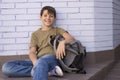 Cheerful child carrying his backpack