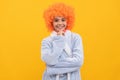 cheerful child in fancy orange wig hair wear home bathrobe, morning