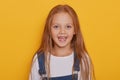 Cheerful child without front teeth posing with opened mouth and funny smile. Nice little blonde girl with milk teeth fell out, Royalty Free Stock Photo