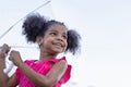 Cheerful child girl with an umbrella playing with rain in the park, Cute little kid girl playing outdoors in the garden