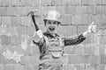 cheerful child laborer using building uniform and hammer tool, laborer