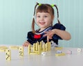 Cheerful child playing with small toys at table Royalty Free Stock Photo