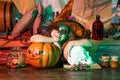 Cheerful child with pumpkins and candy. Happy Halloween Cute girl child making funny faces with a pumpkin. Funny child Royalty Free Stock Photo