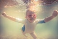 Cheerful child swimming underwater during beach holidays