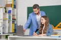 cheerful child with teacher in classroom use laptop Royalty Free Stock Photo