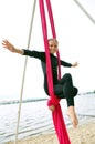 Cheerful child training on aerial silks