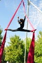 Cheerful child training on aerial silks