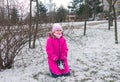 cheerful child 8-9 years old in bright winter clothes