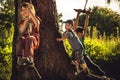 Cheerful children having fun outdoors in forest during summer holidays in countryside symbolizing happy carefree childhood Royalty Free Stock Photo