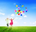 Cheerful Children Playing Balloons Outdoors