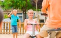 Cheerful children are teetering on the swing Royalty Free Stock Photo