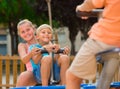 Cheerful children are teetering on the swing Royalty Free Stock Photo