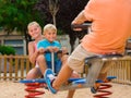 Cheerful children are teetering on the swing Royalty Free Stock Photo