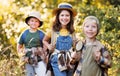 Cheerful children tourists with backpacks went hiking on a summer day and smiles at the camera Royalty Free Stock Photo