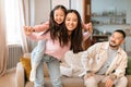 Cheerful Chinese Mom Carrying Baby Daughter Piggyback Playing At Home Royalty Free Stock Photo