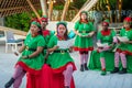 Cheerful christmas elves singing song during celebration party