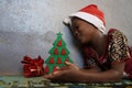 Cheerful Christmas Girl with Christmas Tree and Gift