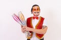 Cheerful circus performer skillfully juggling a number of clubs isolated on white background Royalty Free Stock Photo