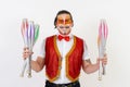 Cheerful circus performer skillfully juggling a number of clubs isolated on white background Royalty Free Stock Photo