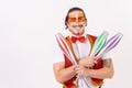 Cheerful circus performer skillfully juggling a number of clubs isolated on white background Royalty Free Stock Photo