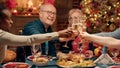 Cheerful close relatives enjoying winter holiday together while drinking sparkling wine Royalty Free Stock Photo