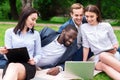 Cheerful colleagues sitting on the grass Royalty Free Stock Photo