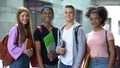 Cheerful college students looking camera outdoor, exchange educational program