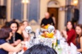 The cheerful company of friends at the festive table, soft focus