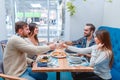 Cheerful company of people in a cafe, drinking champagne and eating a pizza. Royalty Free Stock Photo