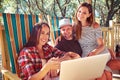 A cheerful company of people looking at a laptop sitting together at resting house