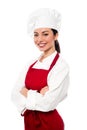 Cheerful confident young female chef